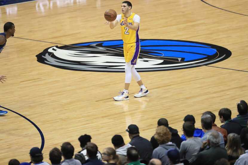 DALLAS, TX - JANUARY 13:  Lonzo Ball #2 of the Los Angeles Lakers passes the ball agains the...