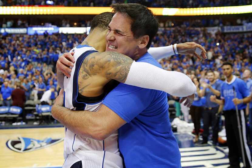 Dallas Mavericks owner Mark Cuban hugs guard Monta Ellis (11) after their thrilling victory...