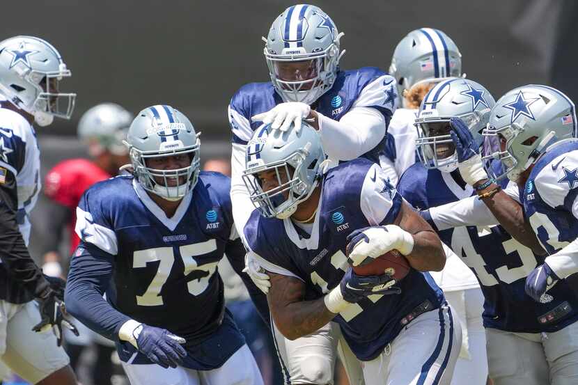 Dallas Cowboys linebacker Micah Parsons (11) celebrates with teammates after intercepting a...