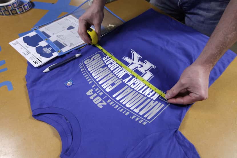 Scott Mitchell checks an official NCAA championship t-shirt proclaiming Kentucky champions...