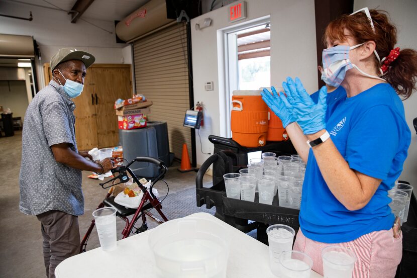 Volunteer Karen Hawkins (right) laughs at Michael Walton's joking remark "Happy...