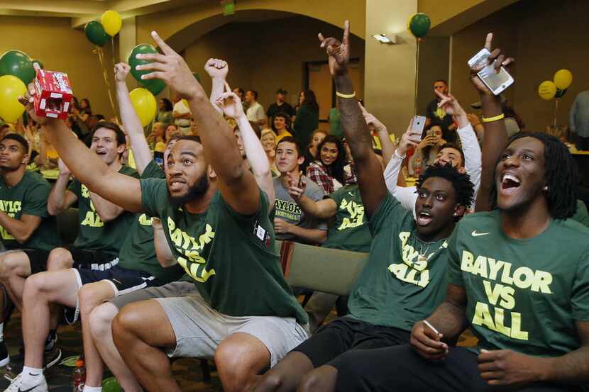 Baylor forward Rico Gathers, left, celebrates with Johnathan Motley and Taurean Prince,...