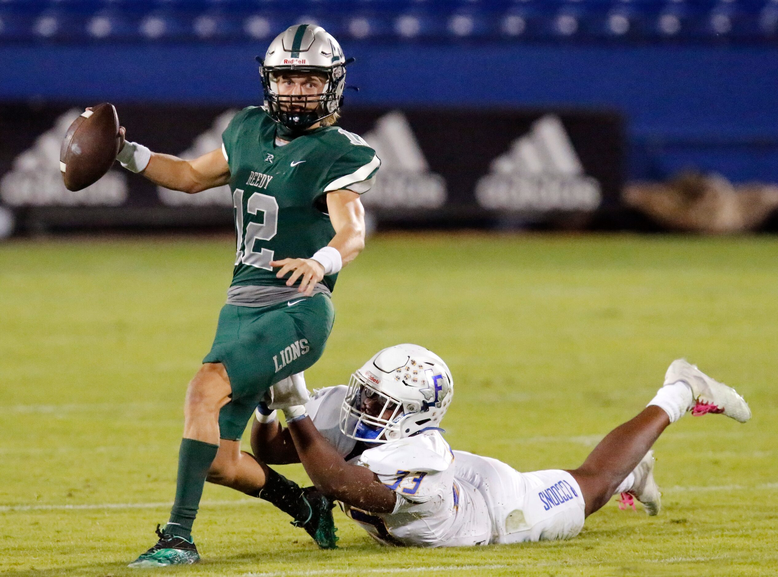 Reedy High School quarterback Caleb Deal (12) is pressured by Frisco High School defensive...