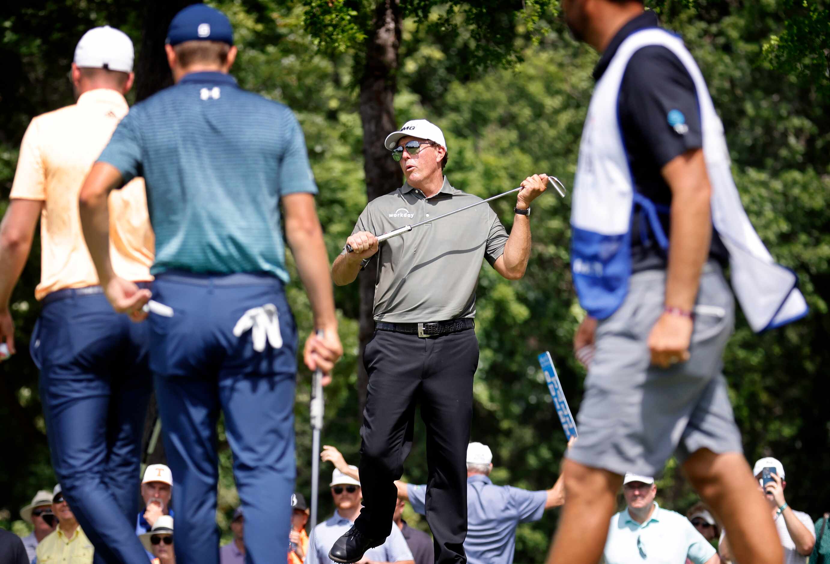 Professional golfer Phil Mickelson reacts to missing a birdie putt on No. 2 during round one...