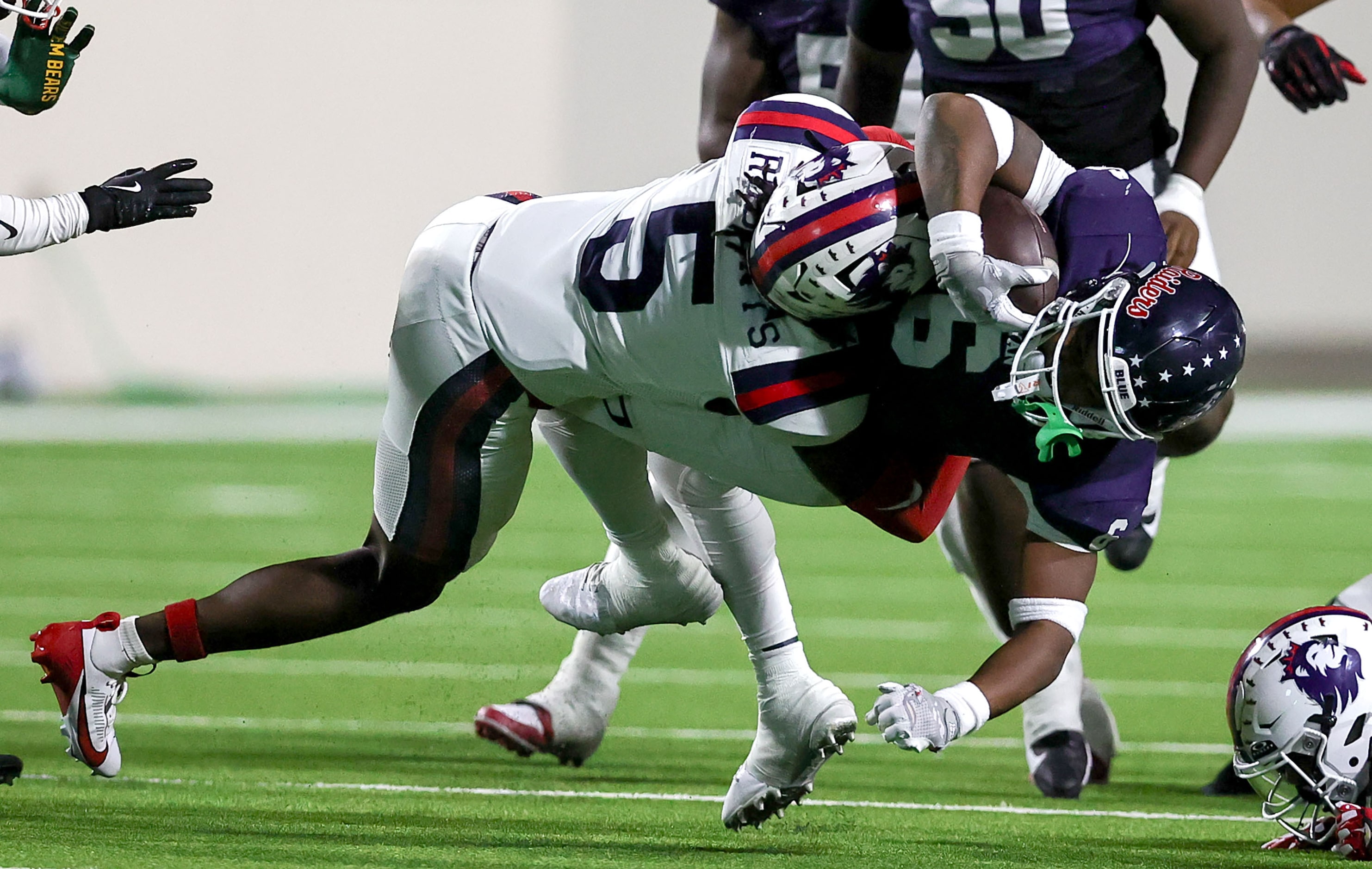 Denton Ryan running back Tre'Vaughn Reynolds (6) gets hit hard by Richland linebacker...