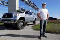 Brian Whittington, with his Toyota Tundra pick-up he uses to tow a single axle trailer for...
