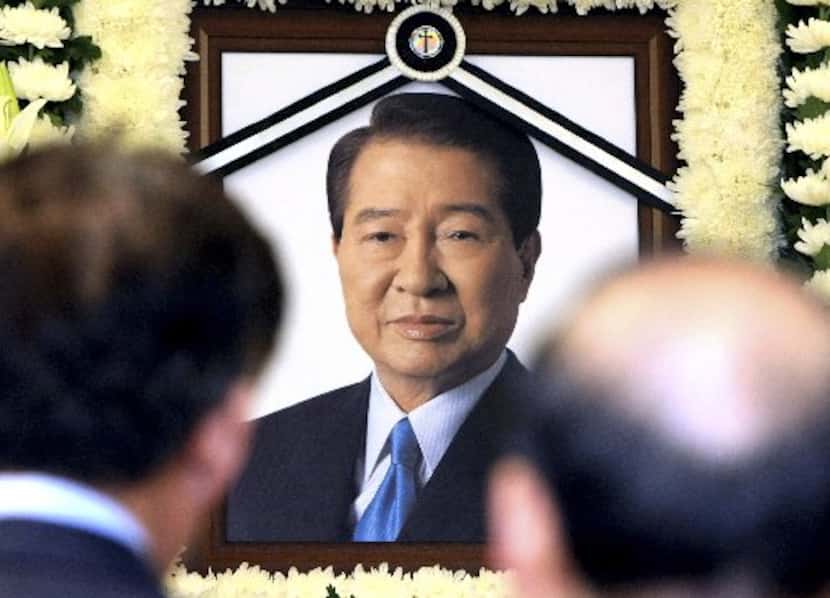 A portrait of the late former South Korean President Kim Dae-jung is seen as mourners visit...