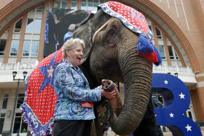 
Linda Herren, Republican National Committee member from Georgia, holds an elephant's trunk...