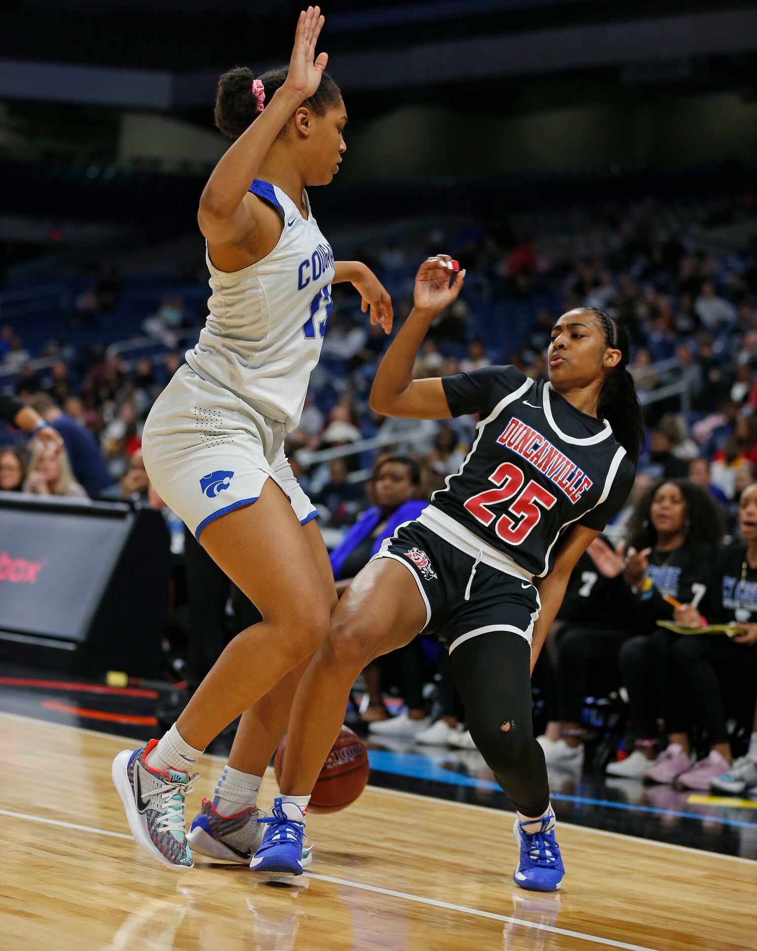 Duncanville guard Deja Kelly #25 is guarded by Cypress Creek forward Riyah Francis #13 but...