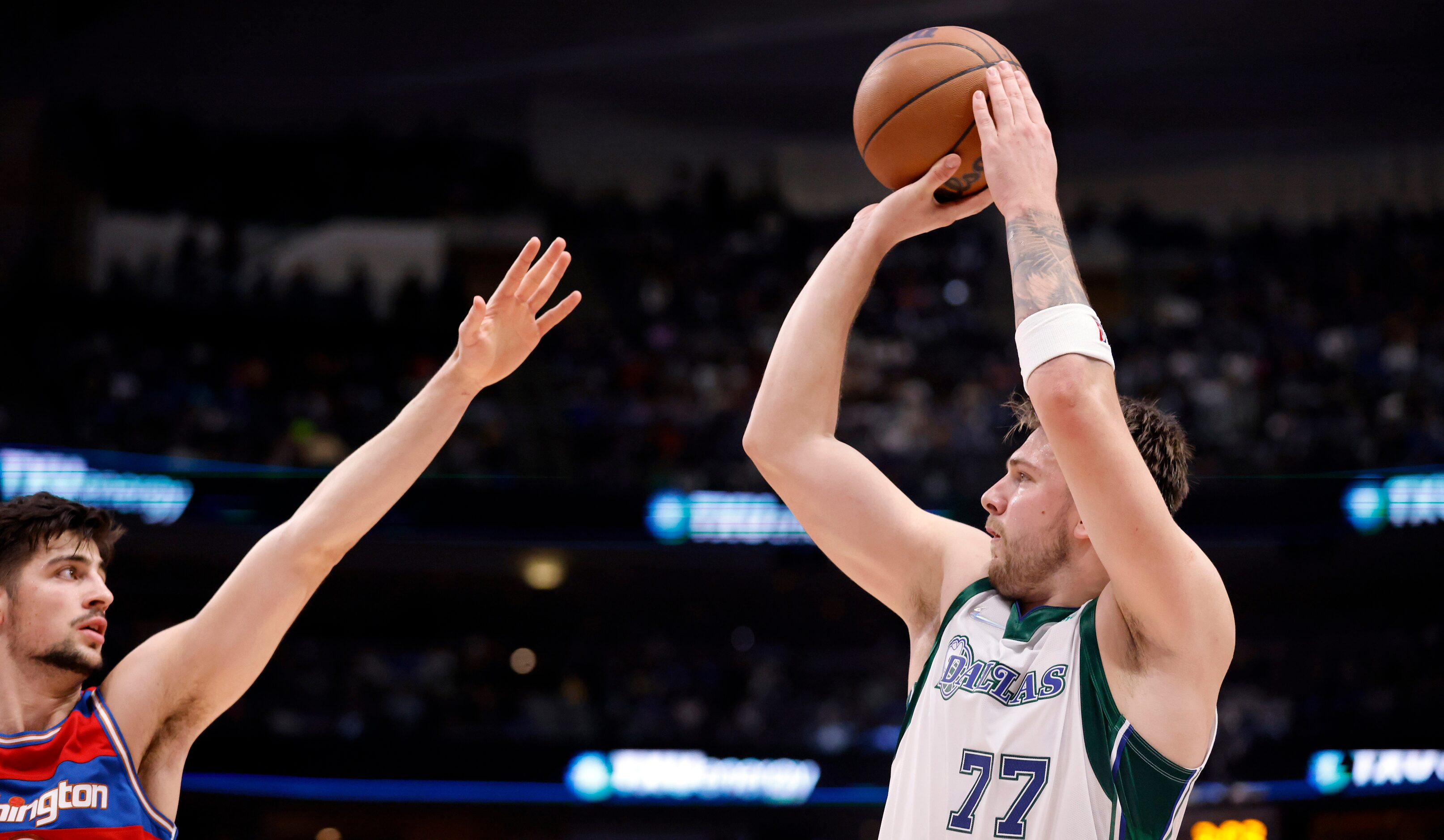 Dallas Mavericks guard Luka Doncic (77) puts up a three-pointer against the Washington...