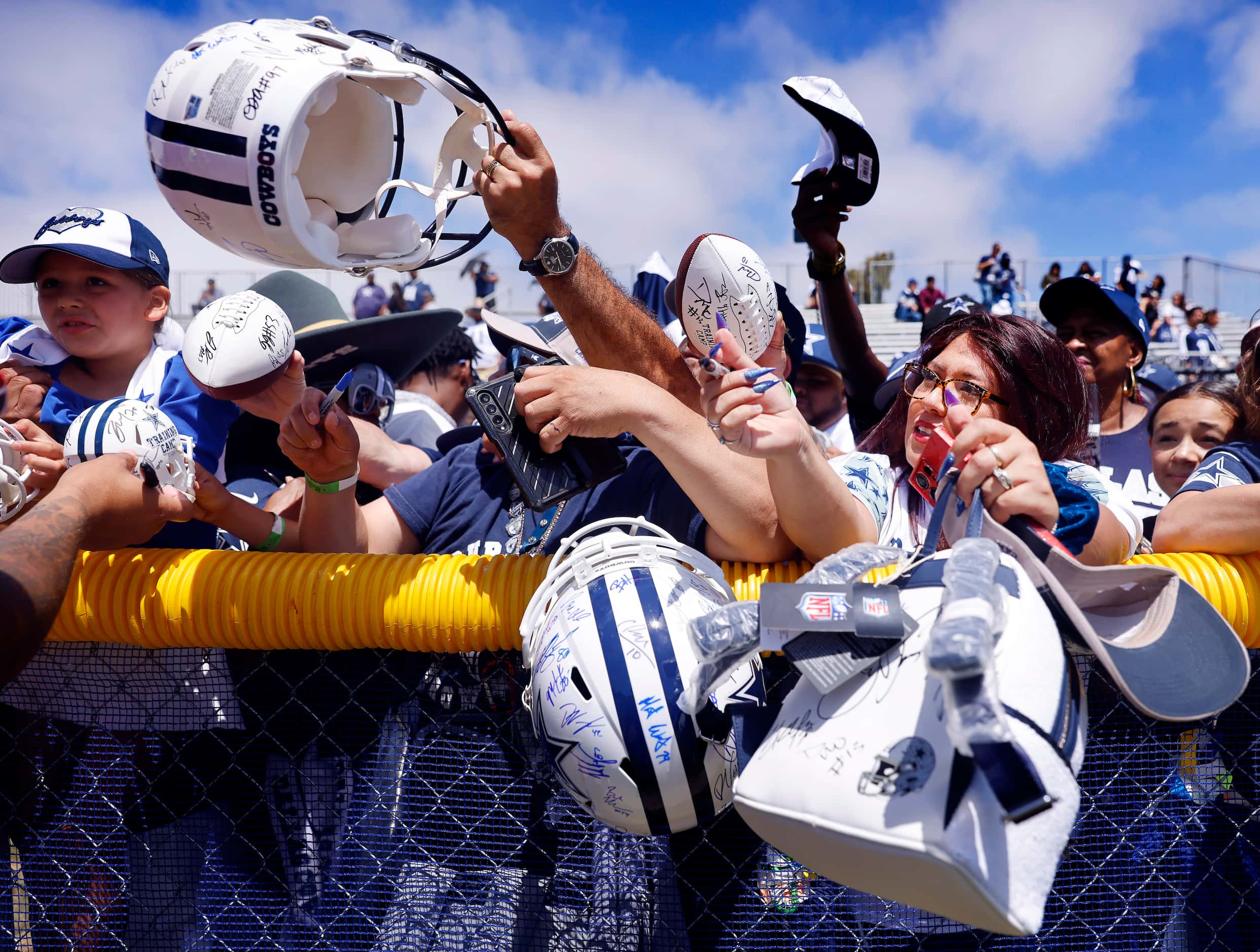 Dallas Cowboys fans reach for an autograph from quarterback Trey Lance following a training...