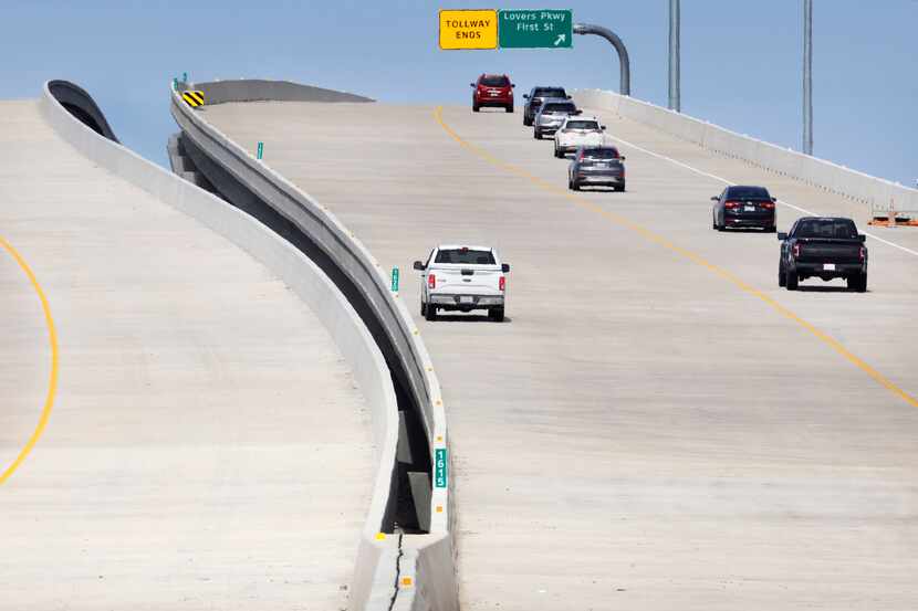 Northbound traffic on the Dallas North Tollway (right) climbs the newly opened bridge over...