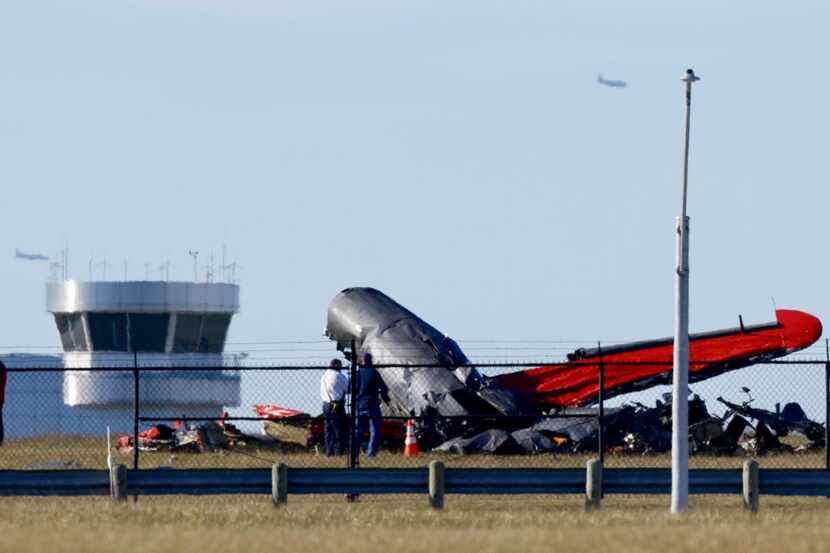 Damage from a midair collision between two planes sits within the fence line of the Dallas...