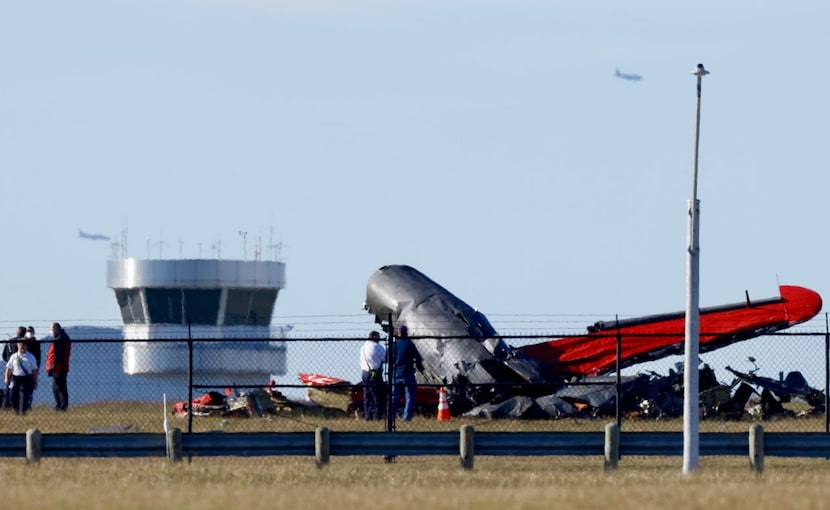 Damage from a mid-air collision between two planes sits within the fence line of the Dallas...