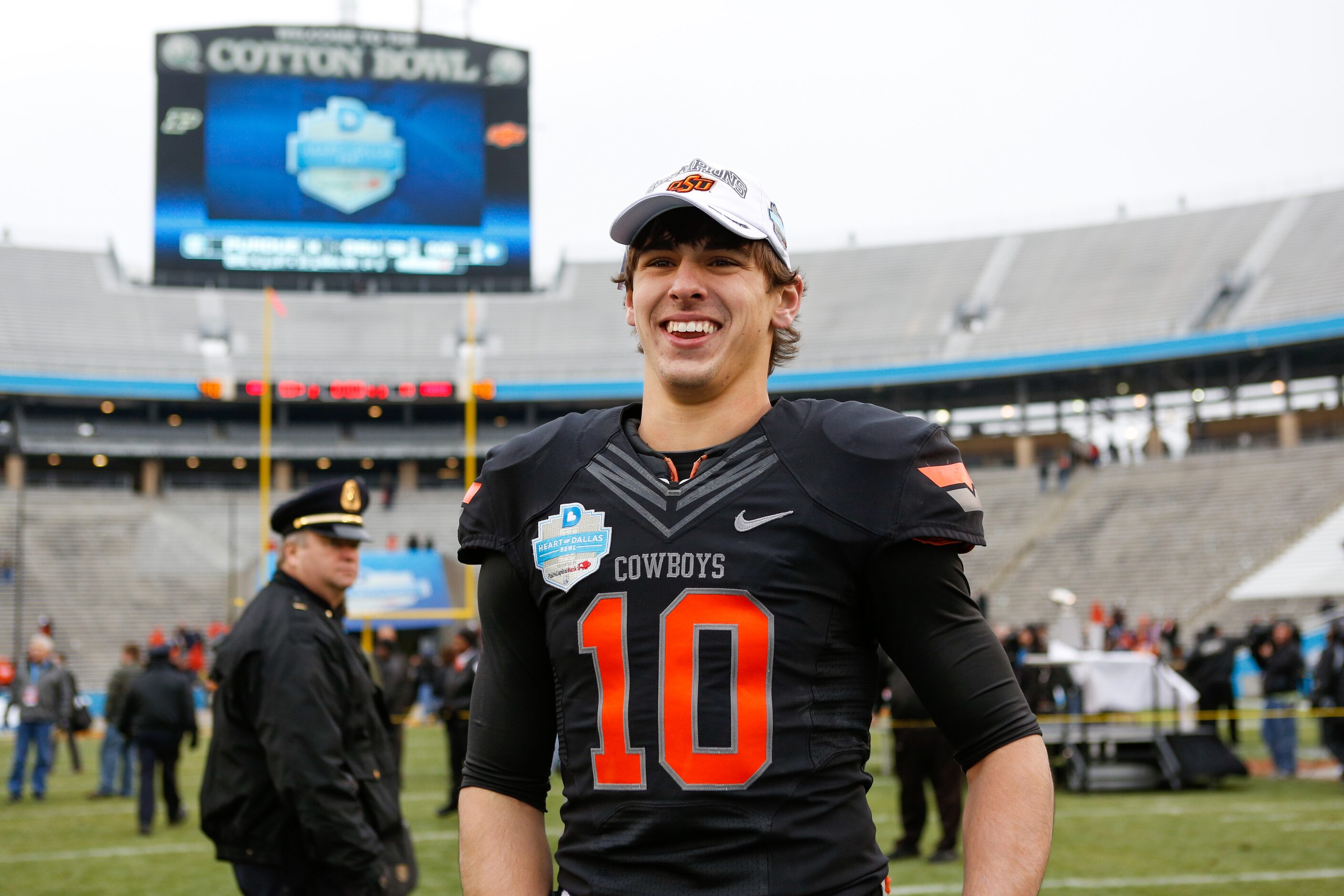 Oklahoma State's Clint Chelf (10) is all smiles after beating Purdue, 58-14, and receiving...