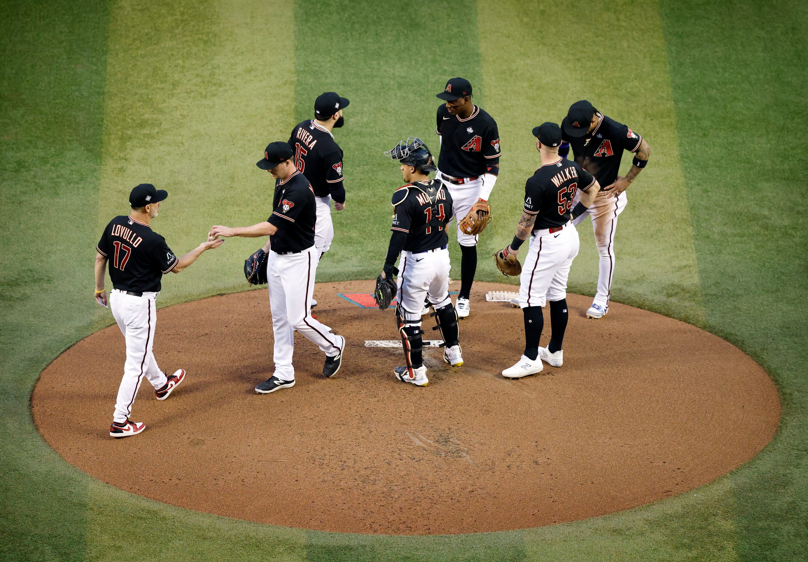 Arizona Diamondbacks starting pitcher Joe Mantiply hands the ball off to manager Torey...