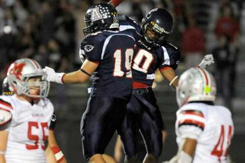 Allen's Andrew Rodriguez (19) and Tony Adams (10) celebrate after Rodriguez touchdown...