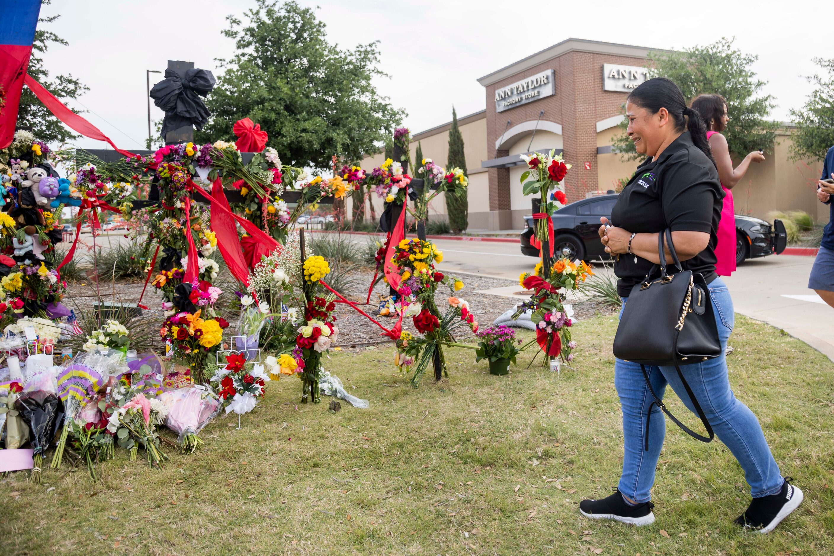 Yvi Beatriz Leon, who was shopping at the time of the shooting, cries while at the memorial...