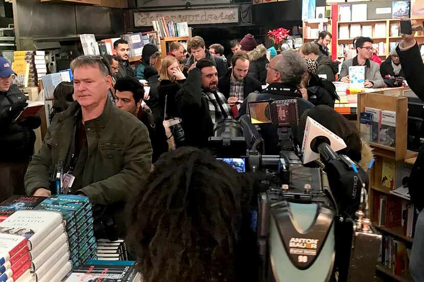 Customers line up at Kramerbooks late Thursday for the midnight sale of Michael Wolff's...