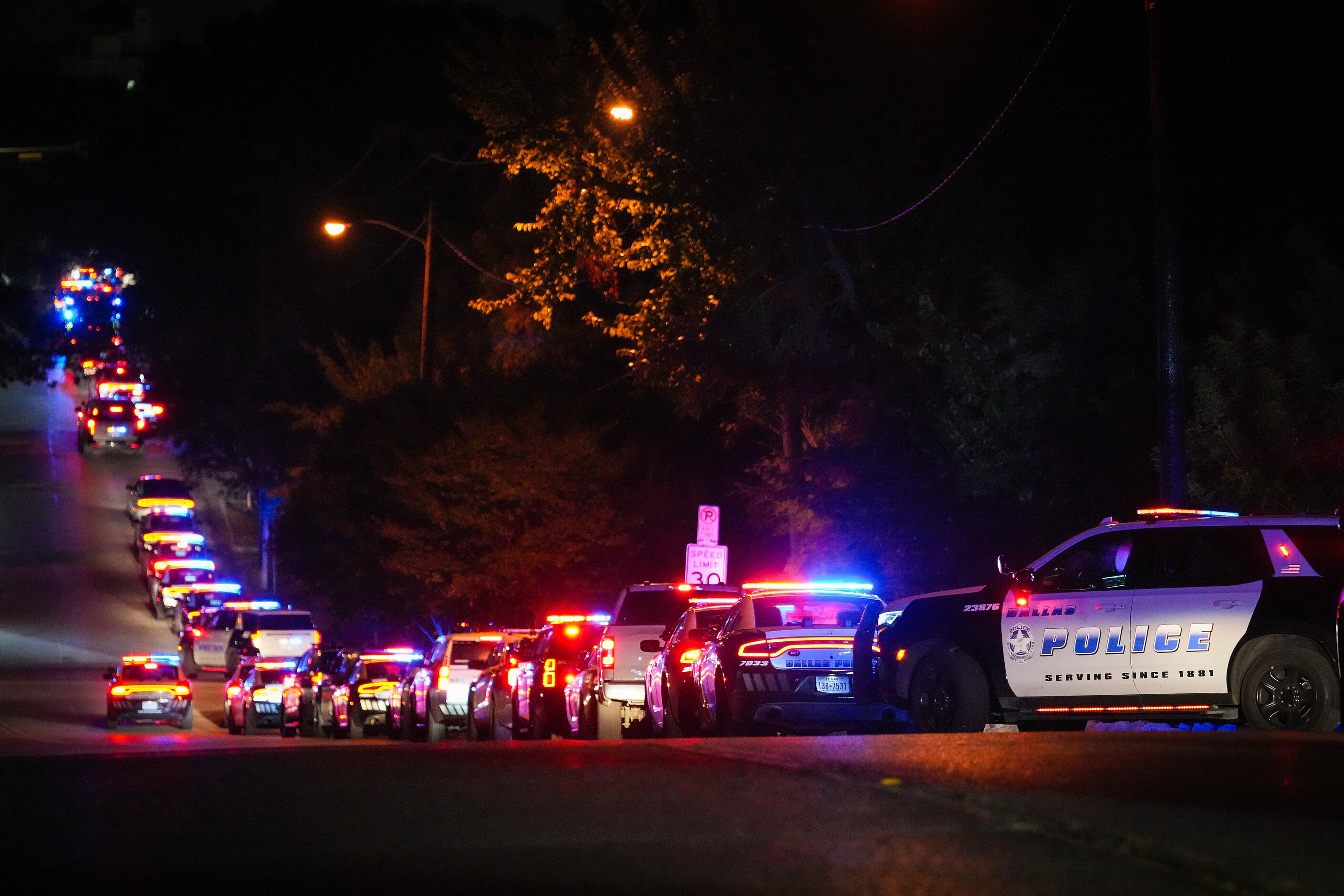 Dallas police stage for a procession from Methodist Dallas Medical Center to the medical...