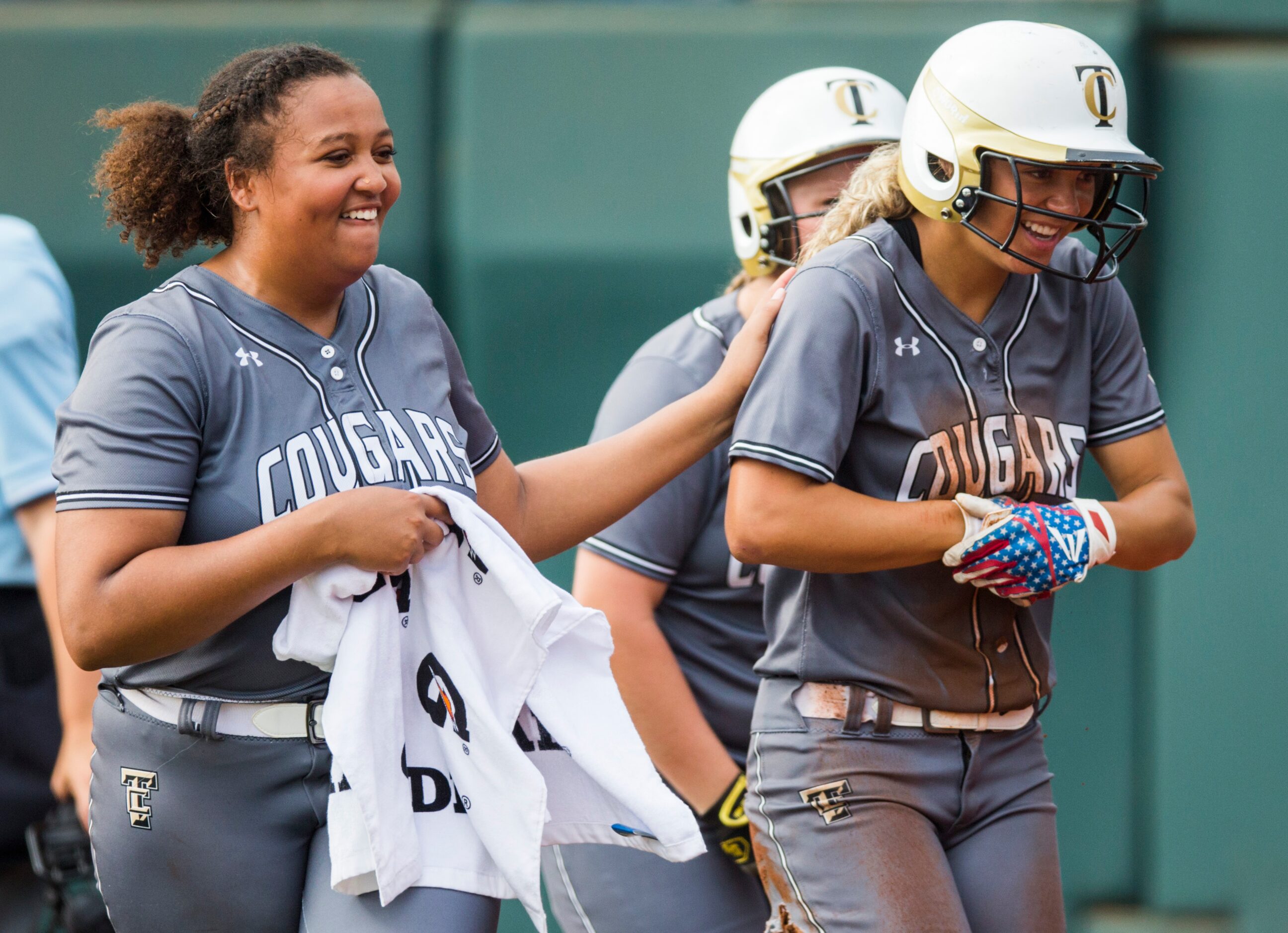 The Colony's Jayda Coleman (10, right) celebrates a run with pitcher Karlie Charles (29)...