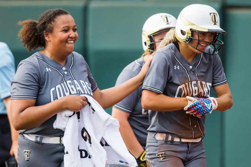 The Colony's Jayda Coleman (right) celebrates a run with pitcher Karlie Charles (29) during...