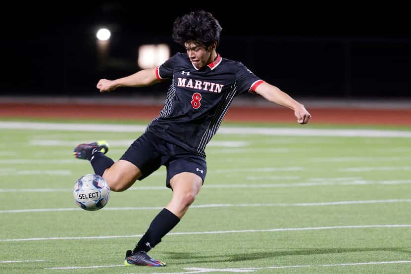 James Martin High School midfielder Joel Romero kicks the ball during a soccer game on...
