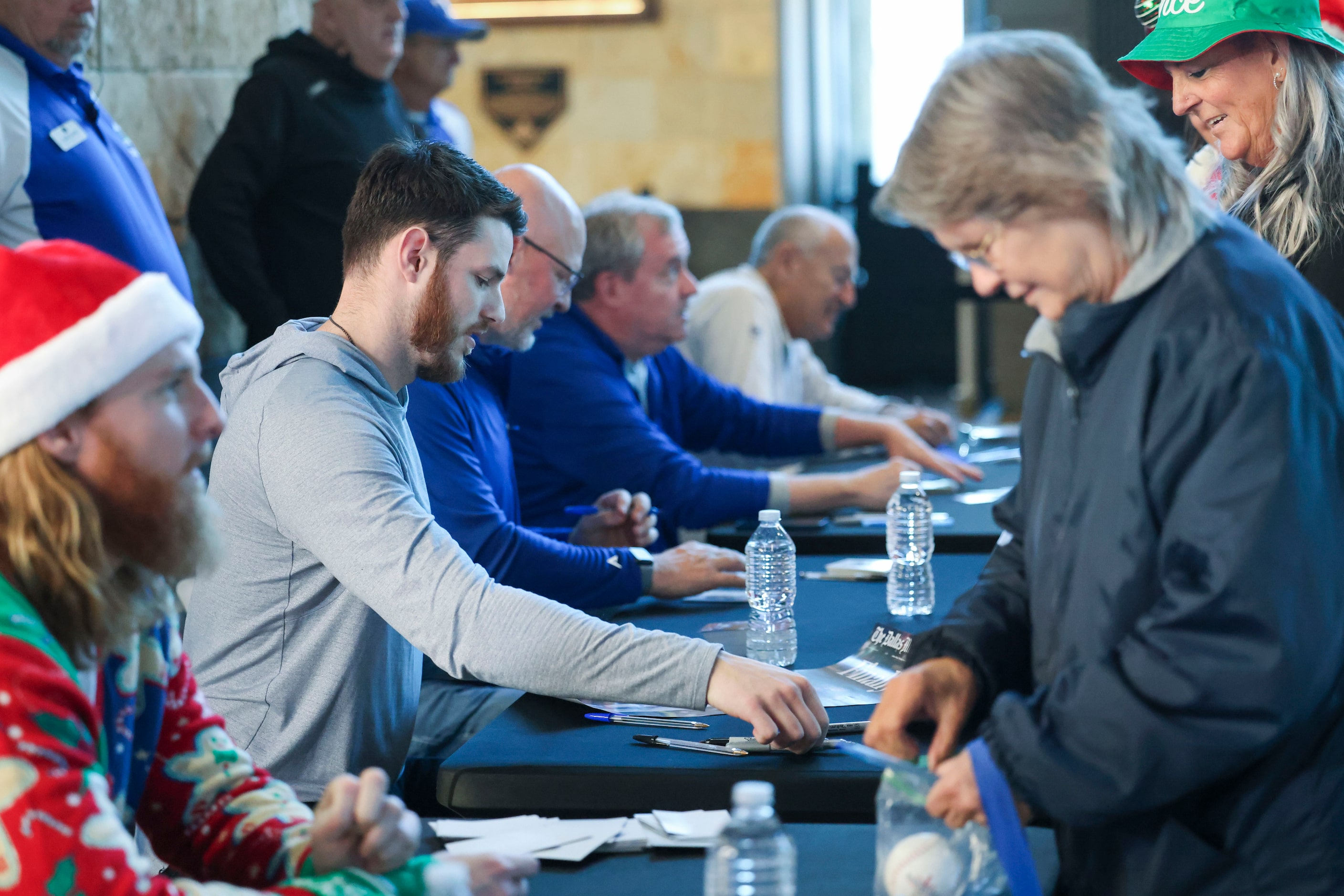 Texas Rangers catcher Jonah Heim interacts with fans while signing autographs during Texas...