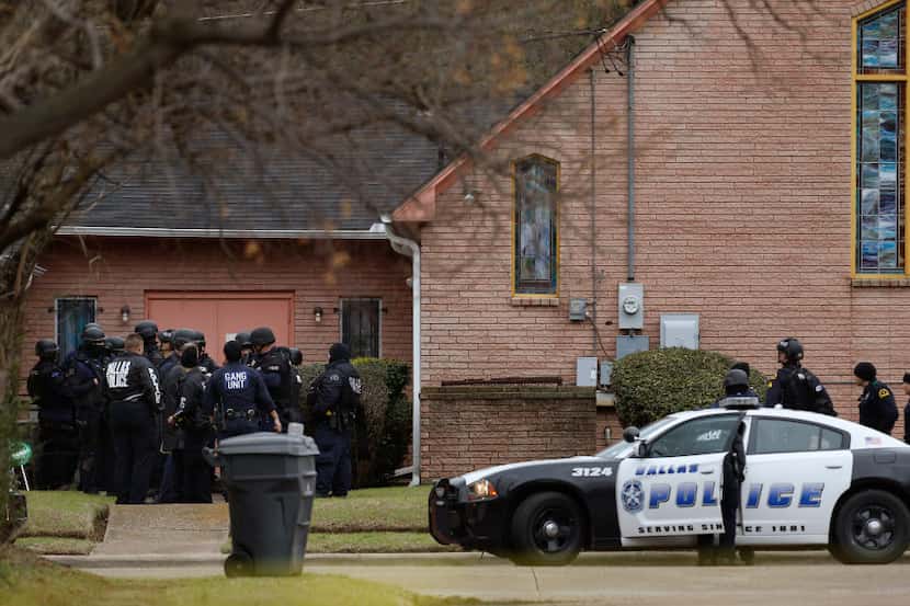 Dallas Police and SWAT gather around Olivet Missionary Baptist Church after a person who...