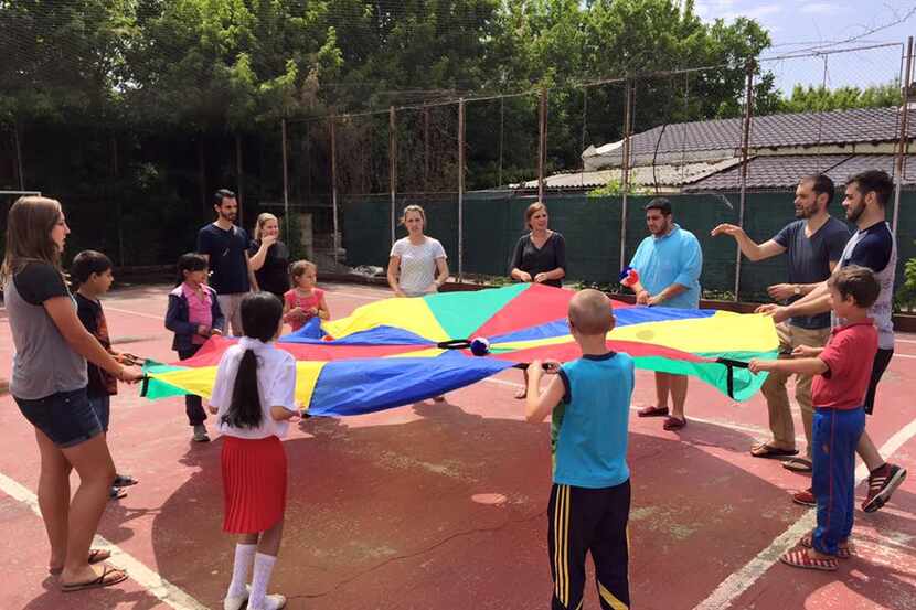  UNT students play with children from low-income families at the Ruth School in Bucharest,...