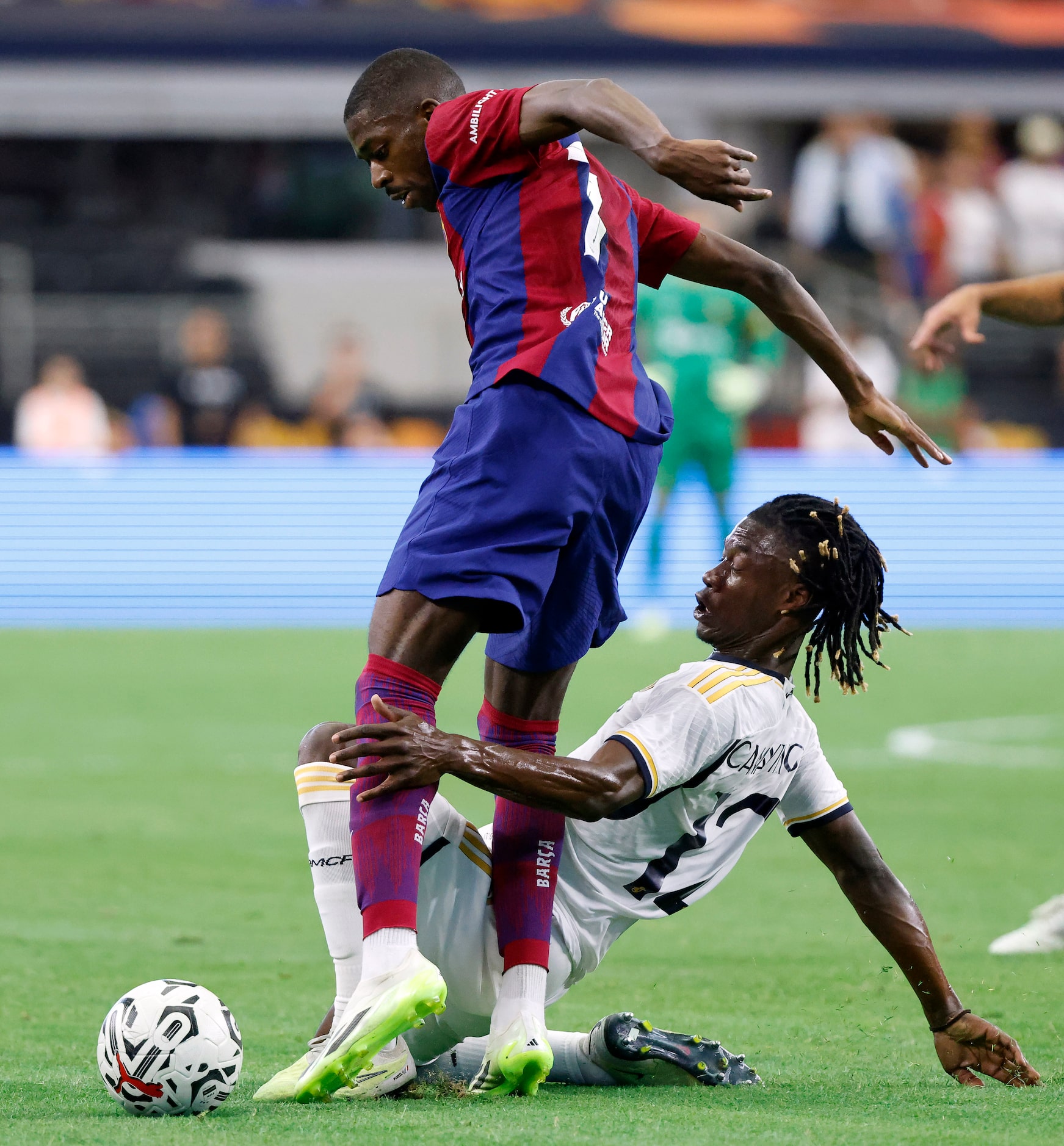 Barcelona forward Ousmane Dembélé (7) and Real Madrid midfielder Eduardo Camavinga (12)...