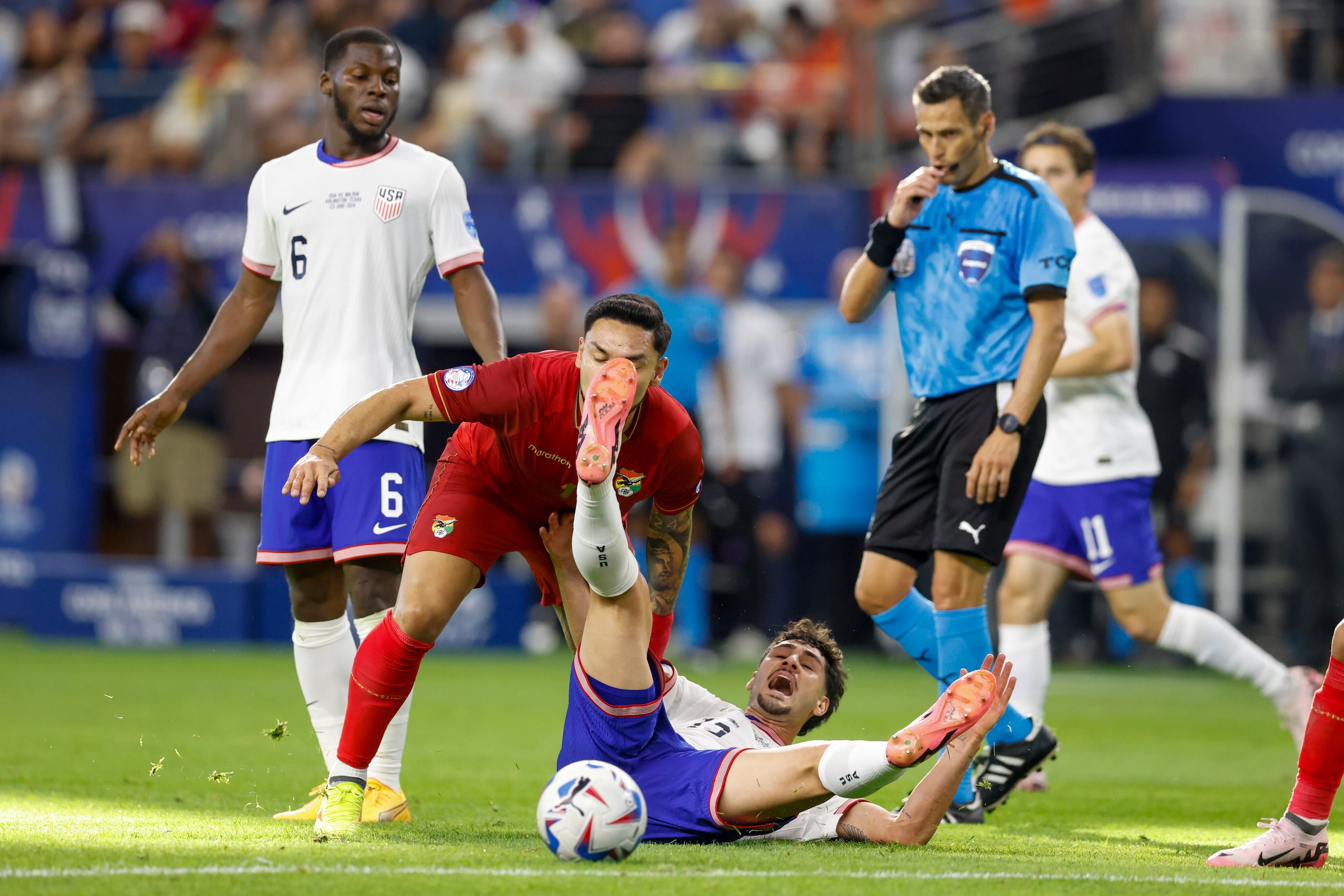 Bolivia forward Carmelo Algarañaz (11) fouls United States midfielder Johnny Cardoso (15)...