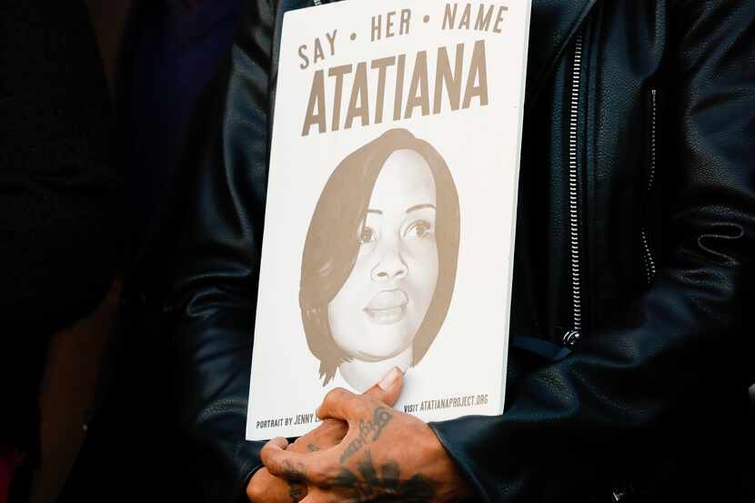 A poster with Atatiana Jefferson’s name and face and text, including, “Say her name,” is...