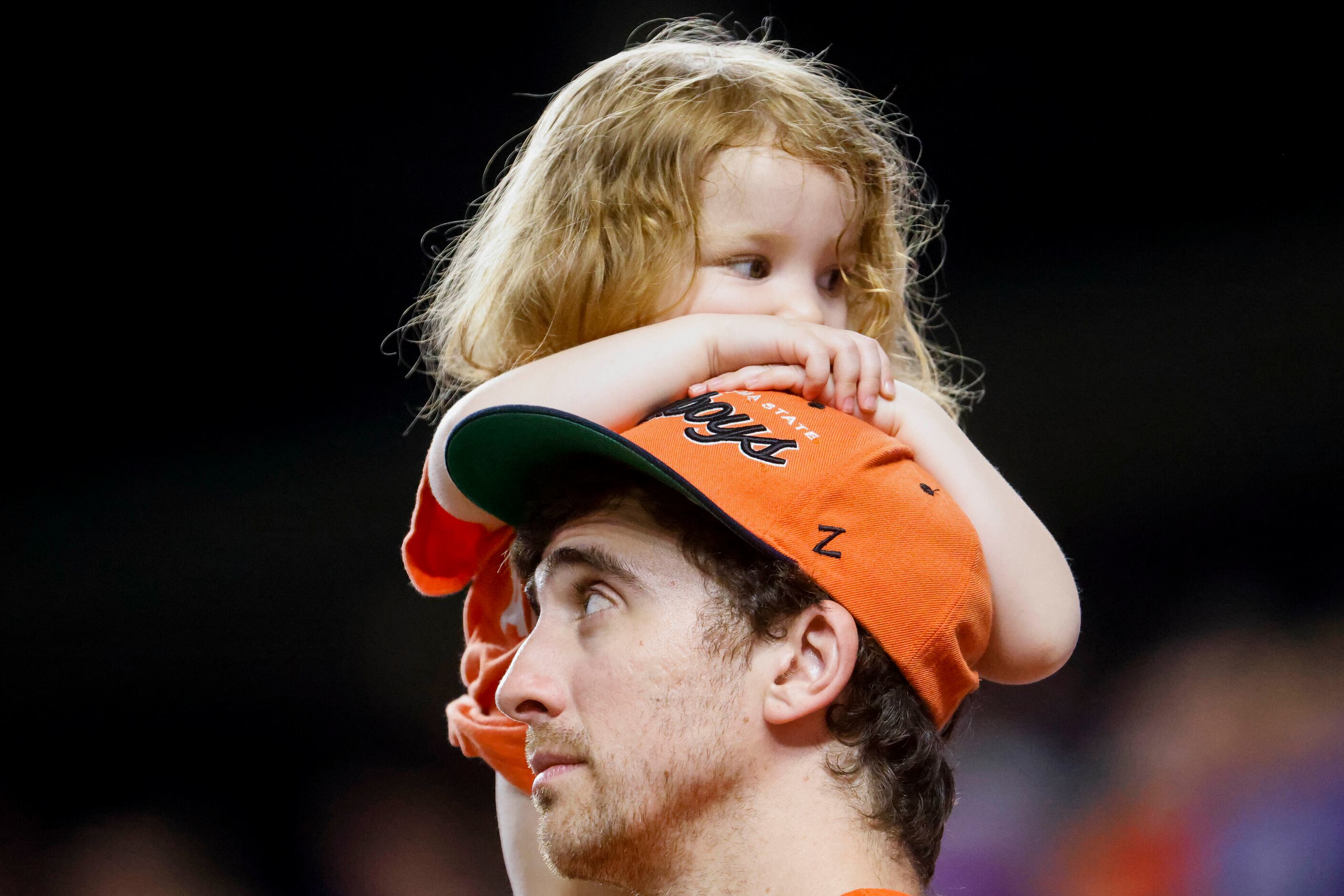 A young Oklahoma St. state fan looks away as fans watch the eighth inning of Big 12 baseball...