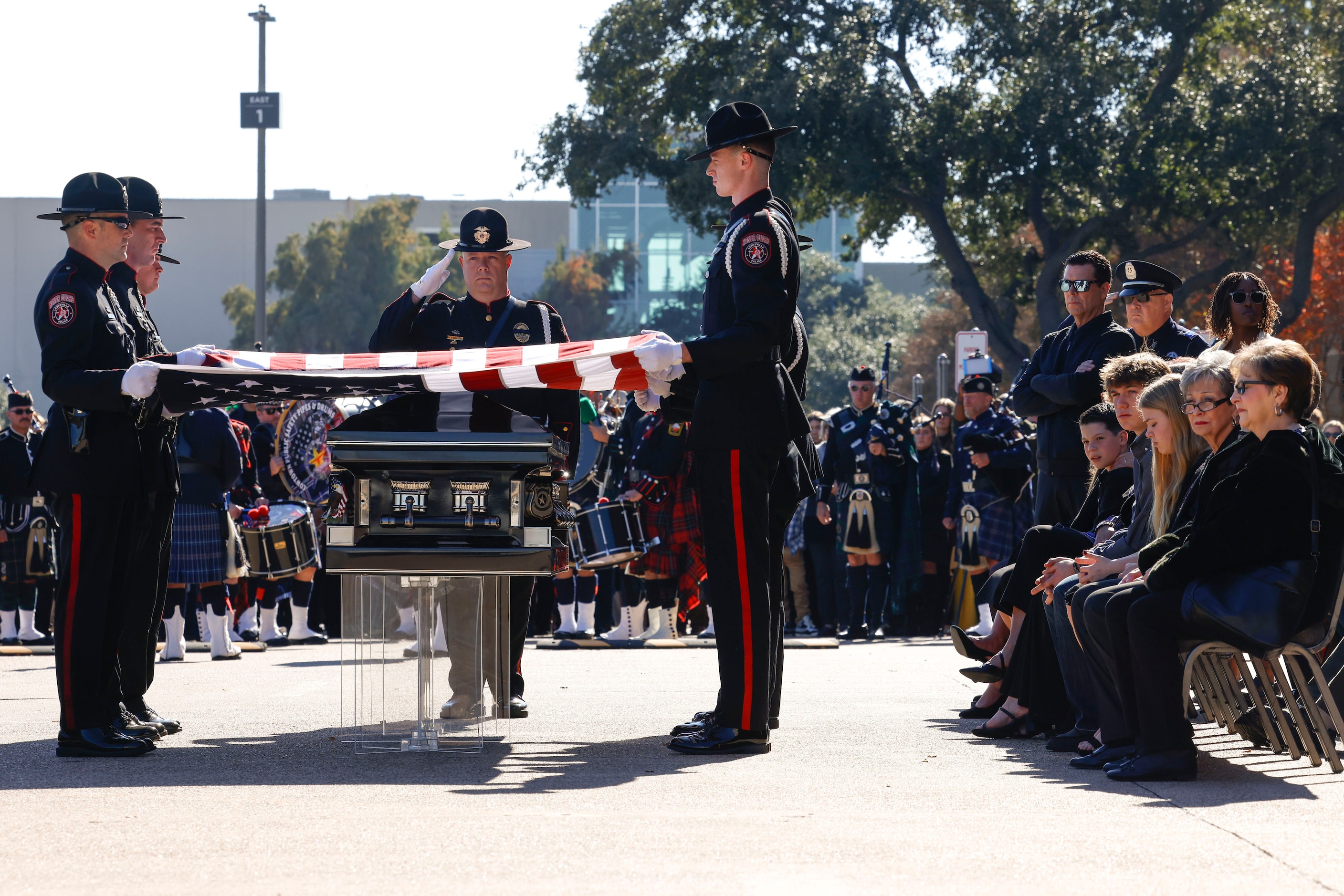 The flag covering the casket of Greenville police officer Cooper Dawson is removed to be...