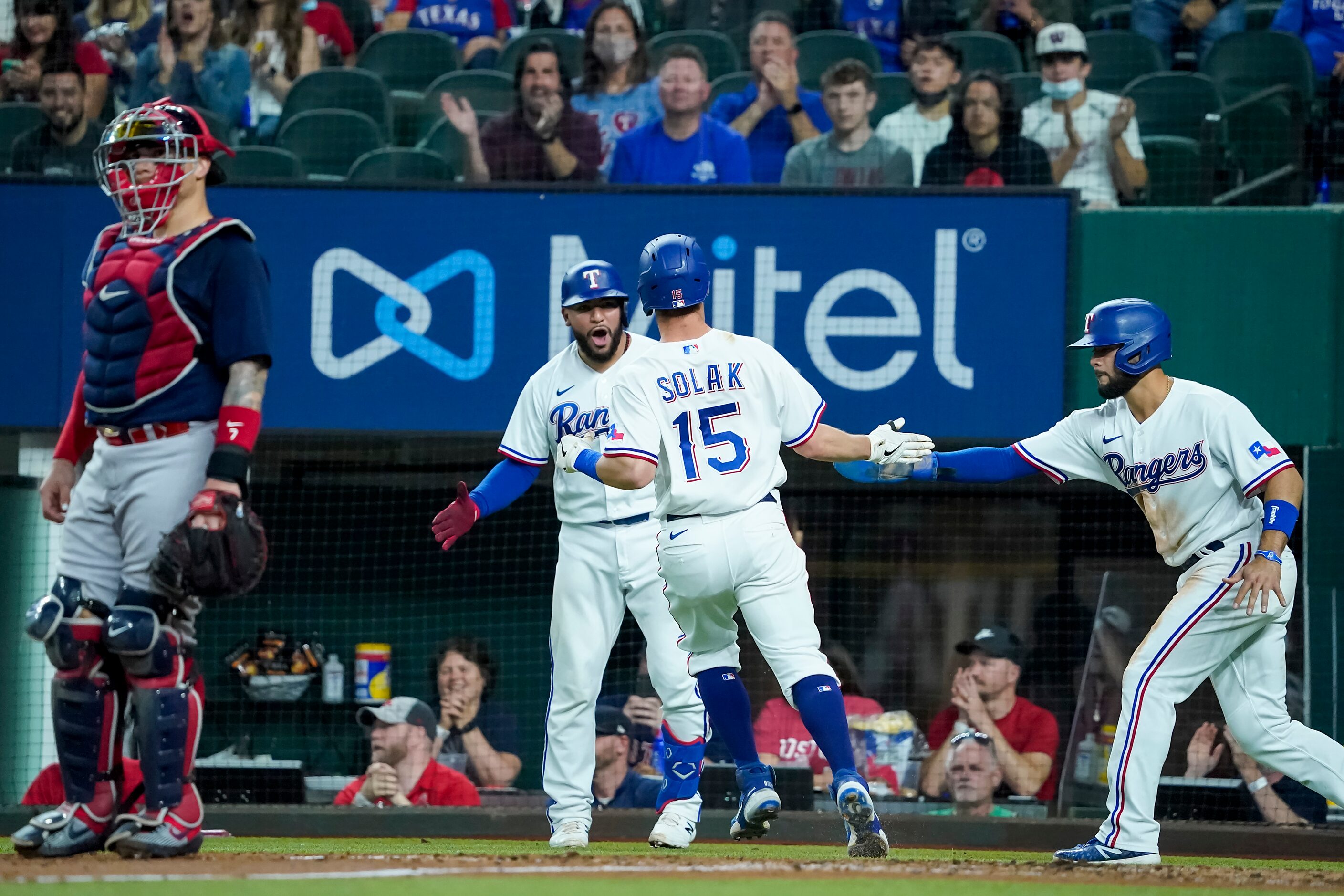 Texas Rangers second baseman Nick Solak (15) celebrates with catcher Jose Trevino and...