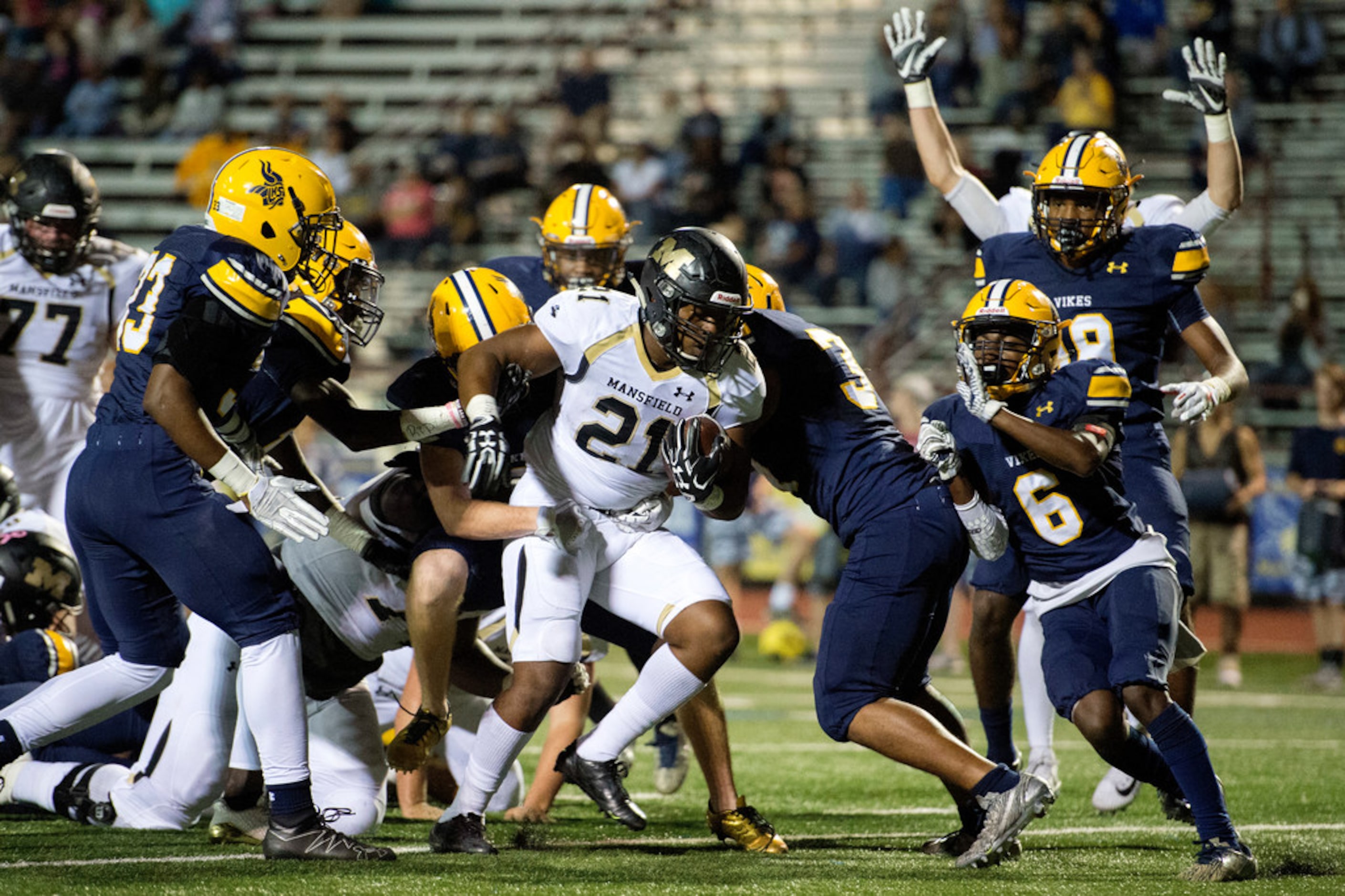 Mansfield senior running back Theo Owens (21) fights through the Arlington Lamar defesne...