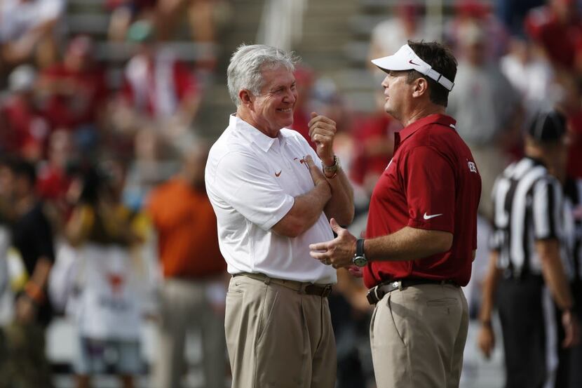 Texas Head Coach Mack Brown talks with Oklahoma Head Coach Bob Stoops before the Red River...
