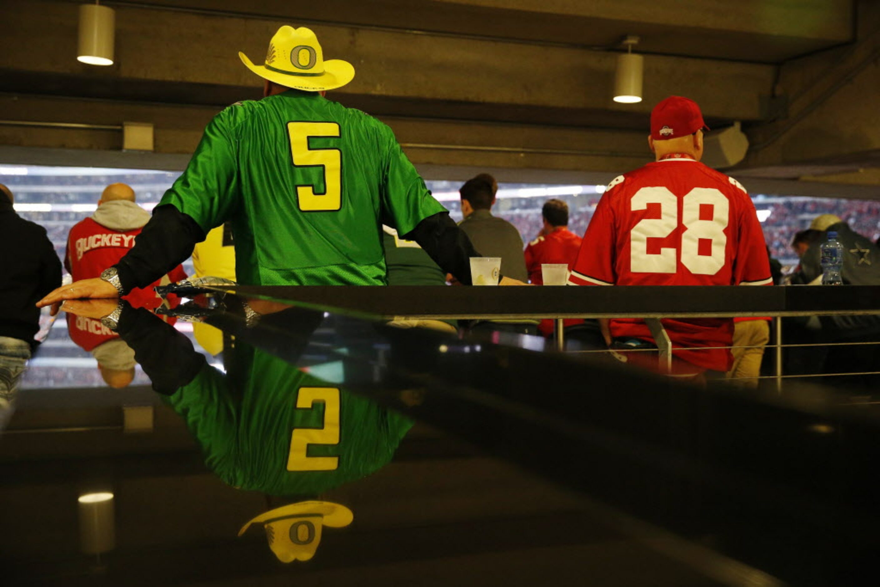 Oregon Ducks fan Jim Van Damme (left), of Boring, Oregon, stand near Ohio State Buckeyes fan...