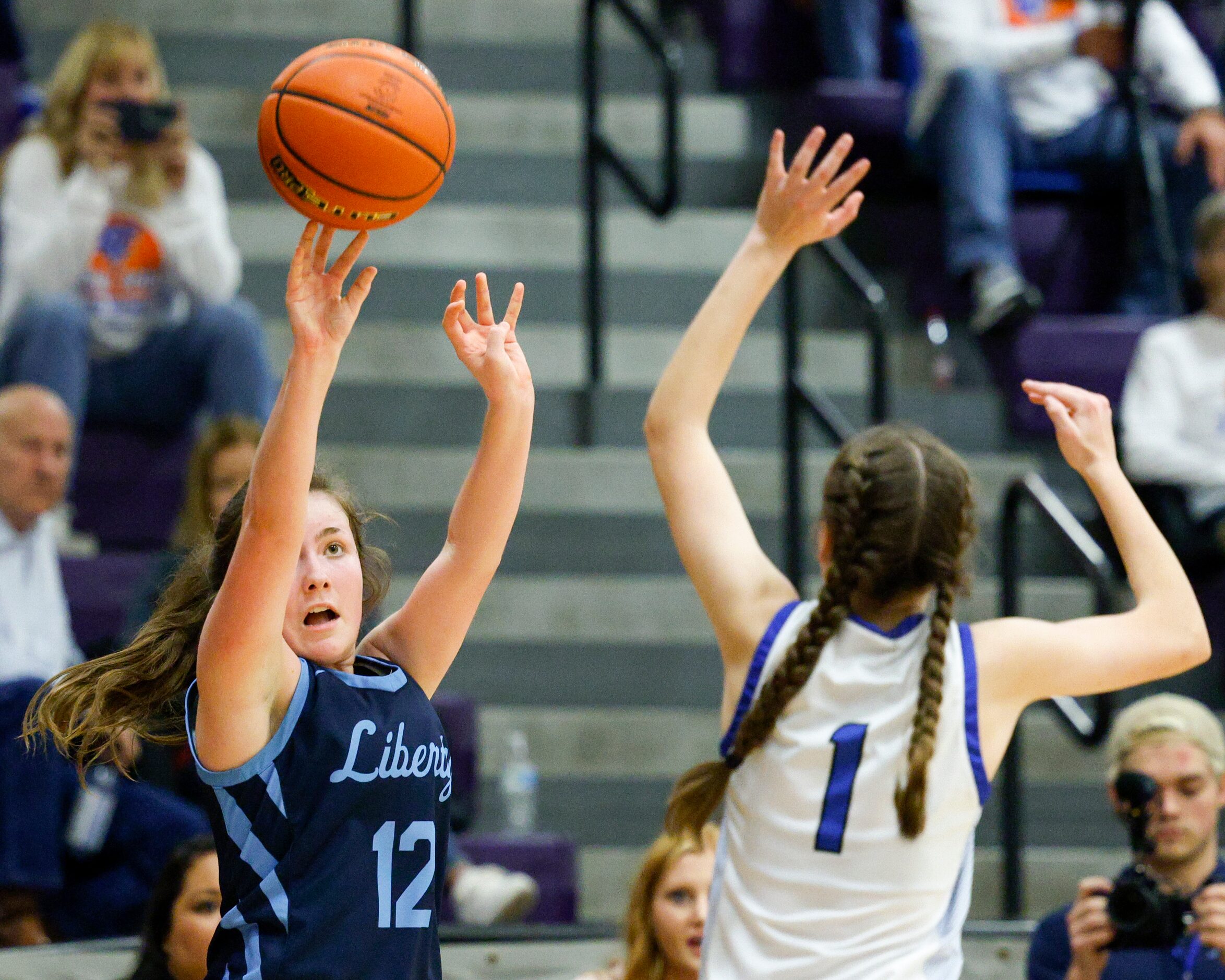 Argyle Liberty Christian guard Elizabeth Egger (12) shoots over a defending Tyler Grace...