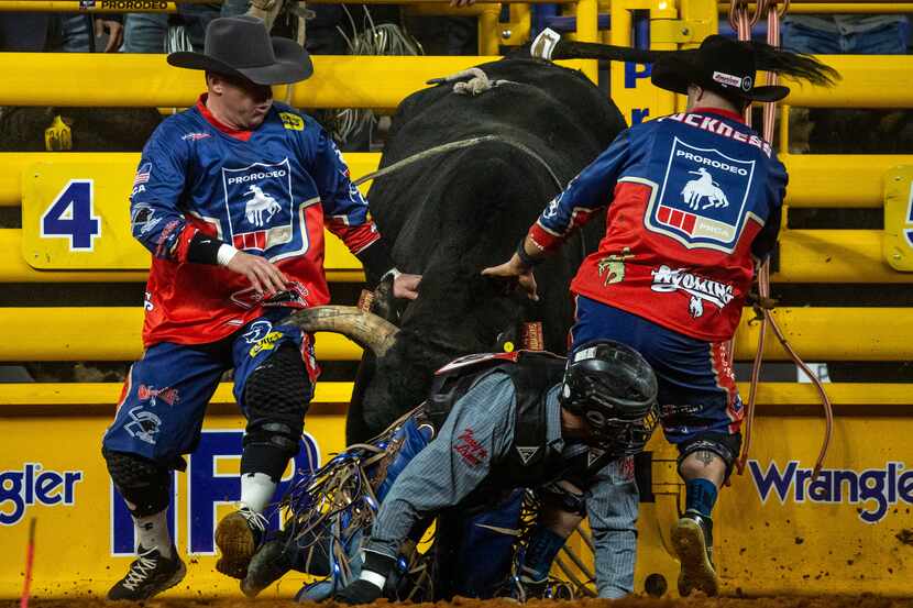 From left, bullfighters Nate Jestes and Dusty Tuckness redirect Audacious the bull during...
