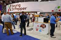 Attendees visit the Keurig Dr Pepper booth during the National Automatic Merchandising...