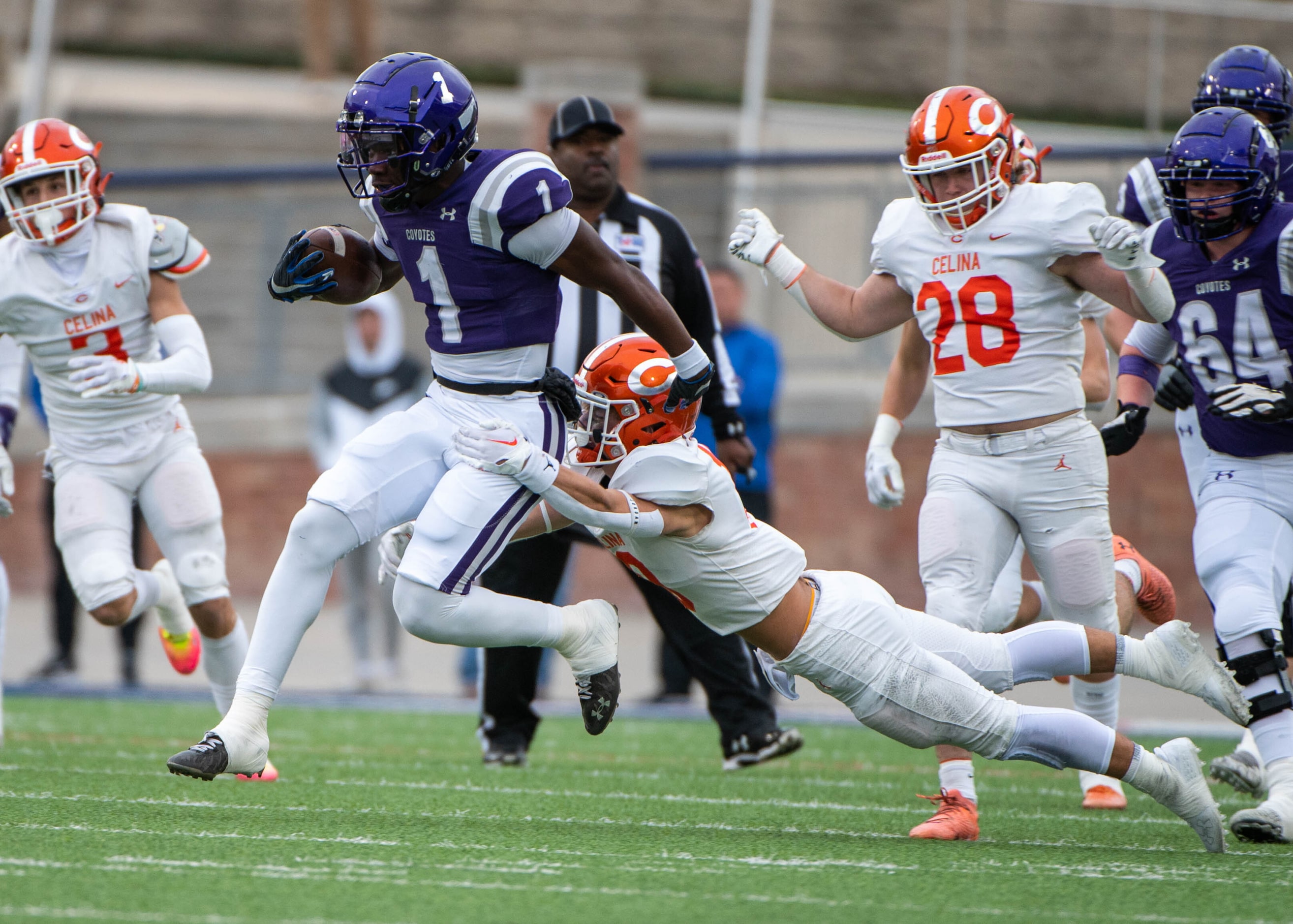 Anna’s running back Breezy Dubar (1) runs past Celina’s Cade Biagini (10) in the first half...