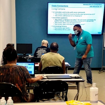 A small class of older adults learn how to purchase a computer, taught by a Senior Source...