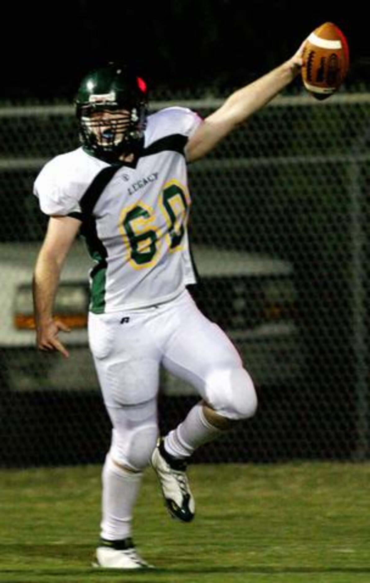 Frisco Legacy Christian Academy's Derek Burns (60) celebrates after scoring a touchdown on a...