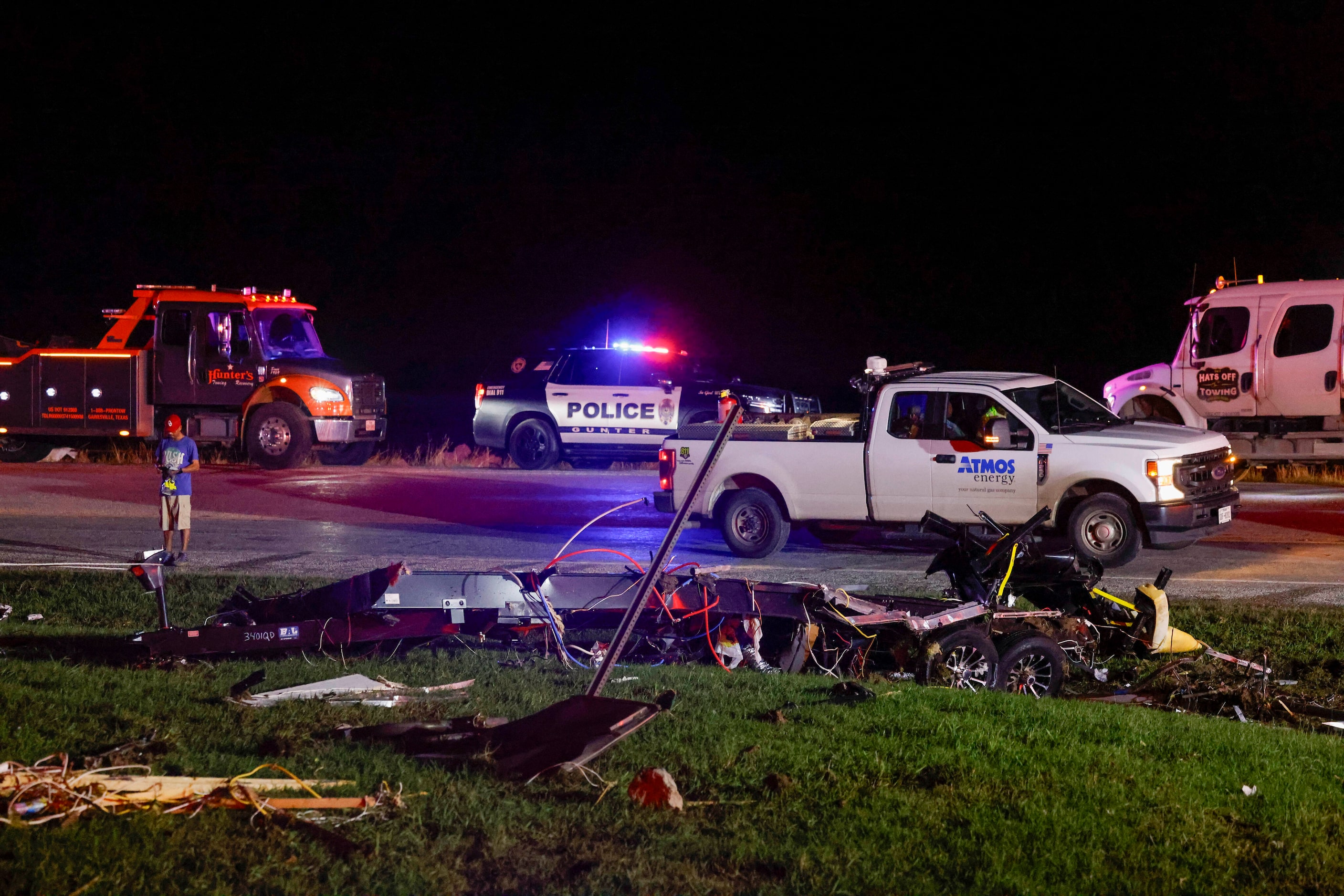 Emergency response vehicles are seen near a Shell gas station after a suspected tornado...