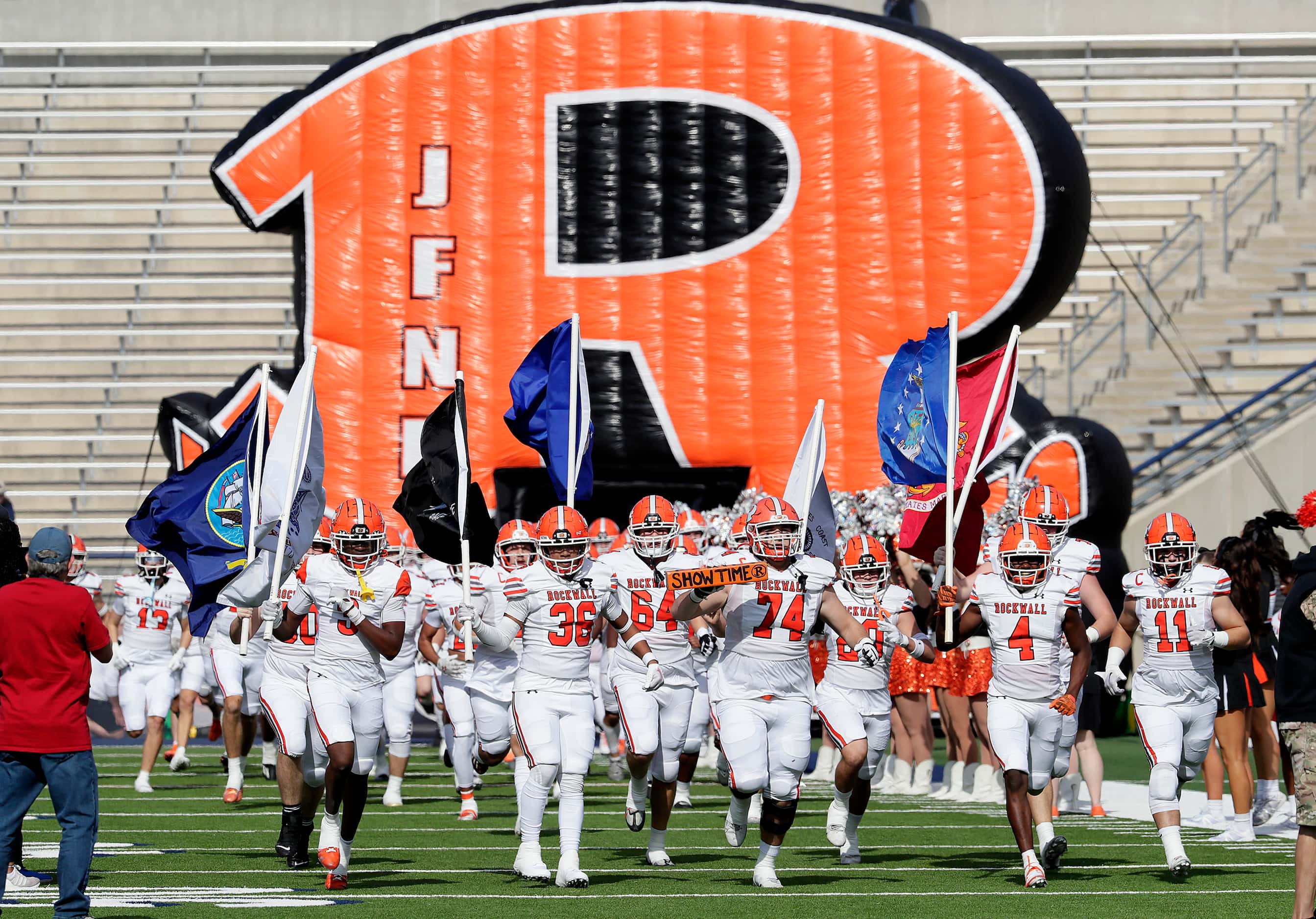 The Rockwall High School football team takes the field before kickoff as Rockwall High...