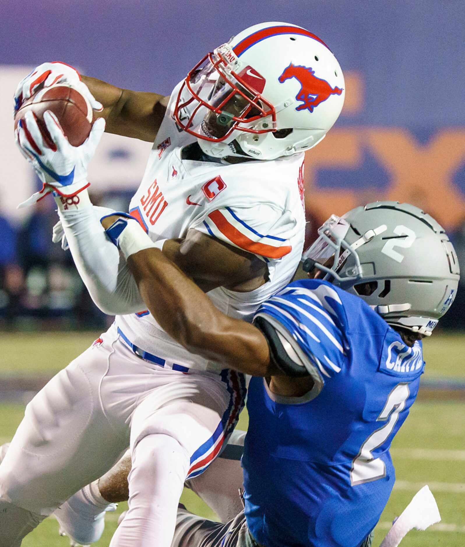 SMU wide receiver James Proche (3) catches a pass as Memphis defensive back T.J. Carter (2)...