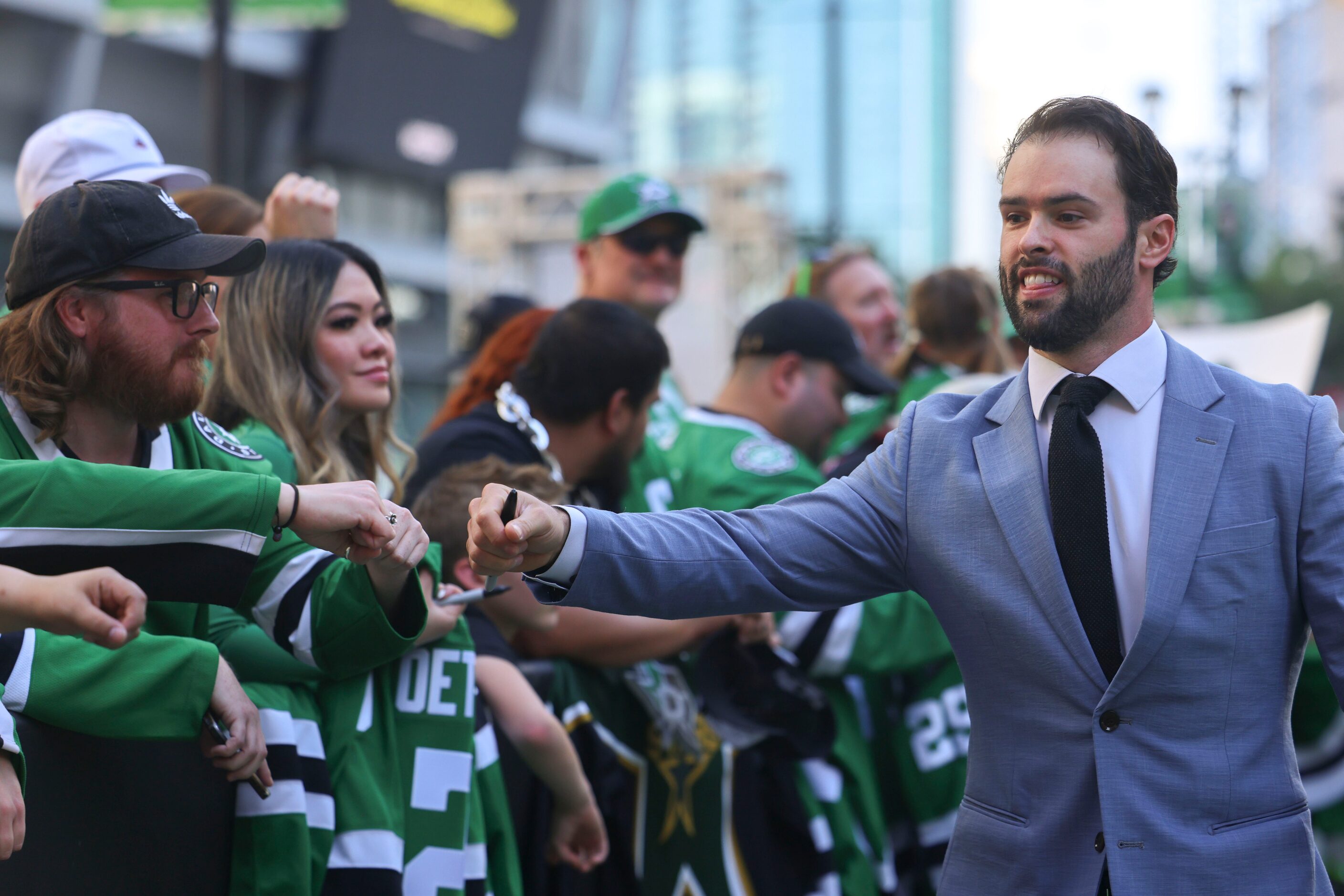 Dallas Stars center Colin Blackwell fist bumps fans as he makes his way during the team’s...