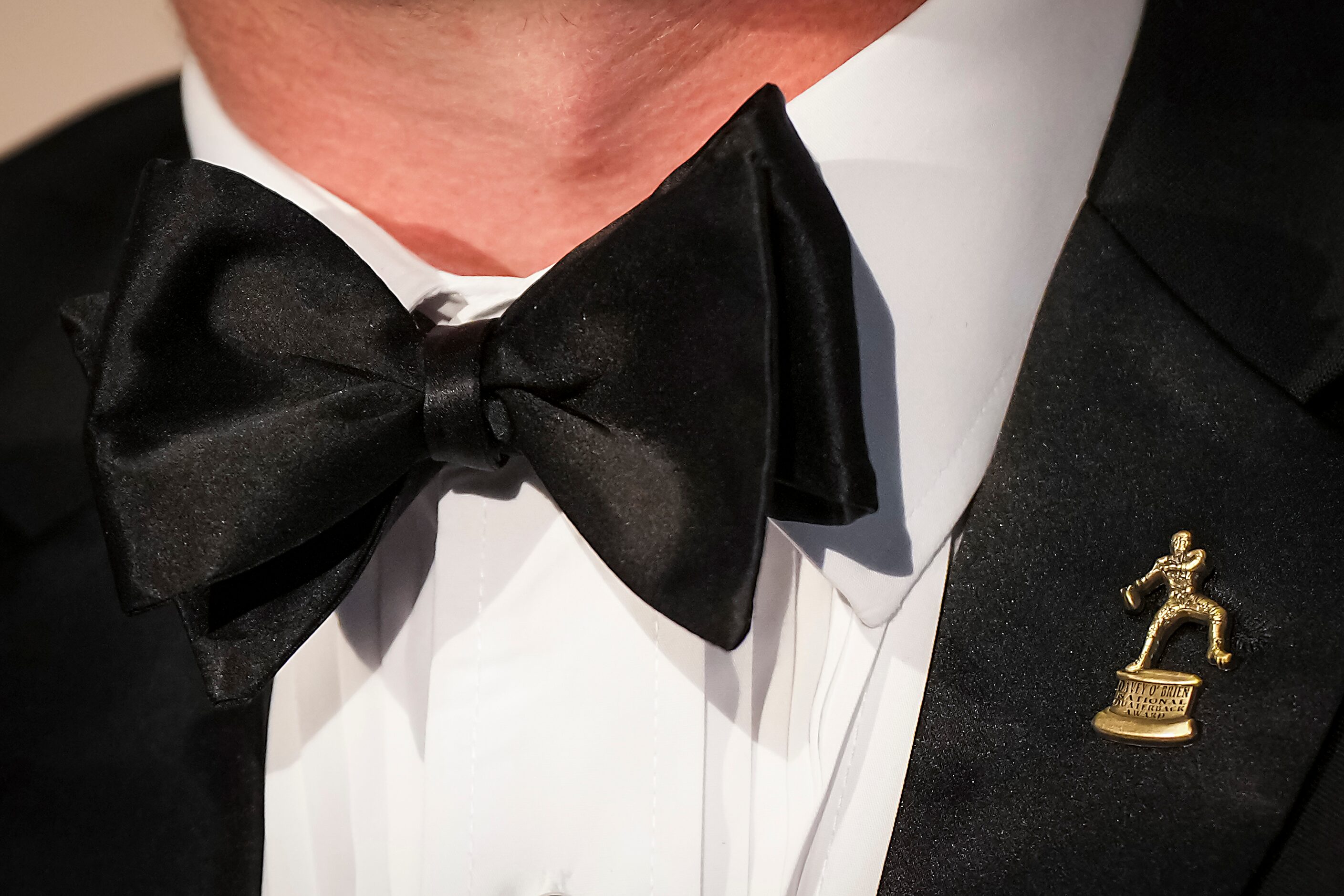 TCU quarterback Max Duggan wears a bowtie and a pin of the Davey O'Brien Award, given to...